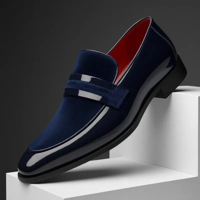 Navy patent leather penny loafer with suede panel and red interior lining