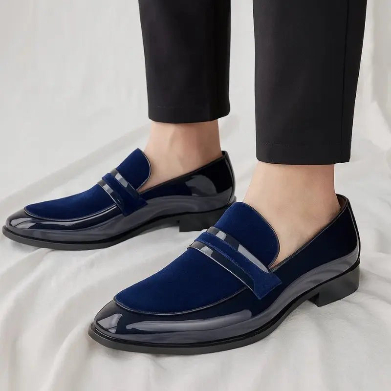Man wearing navy suede and patent leather penny loafers with black trousers