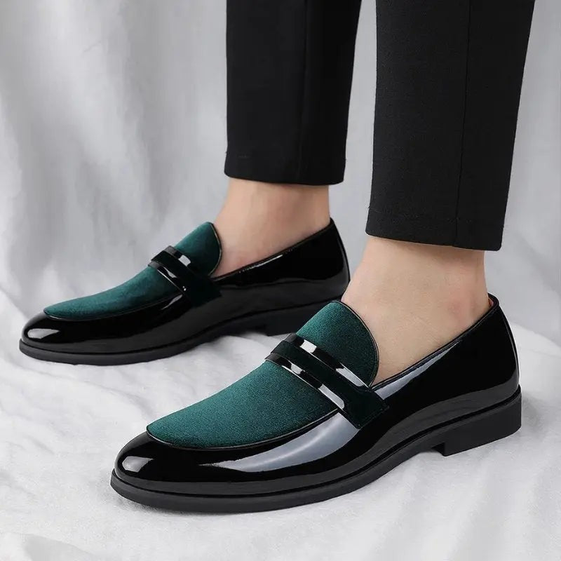 Model wearing black and green suede penny loafers with tailored black trousers