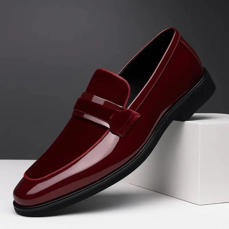 Burgundy patent leather loafer featuring suede trim and pointed toe design