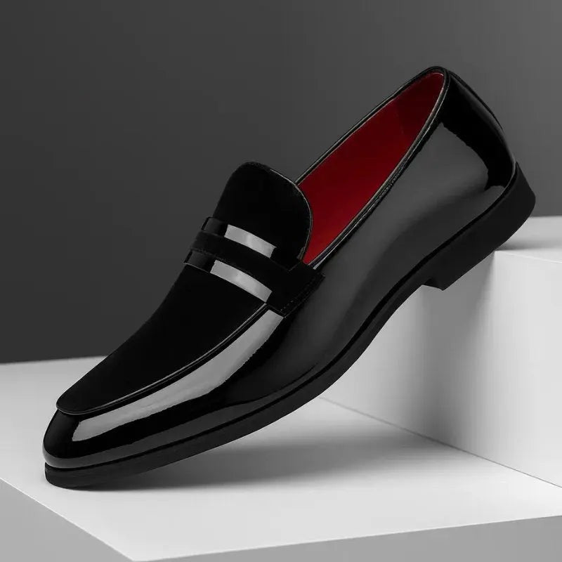 Black patent leather penny loafer with suede strap and red inner lining