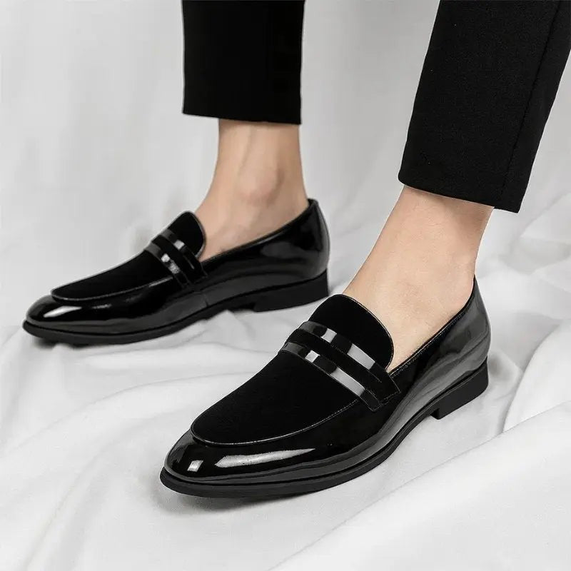 Man modelling black patent and suede loafers paired with slim-fit trousers