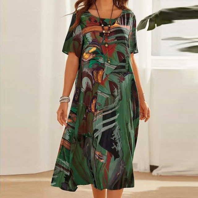 Green abstract print midi dress featuring loose short sleeves and round neckline