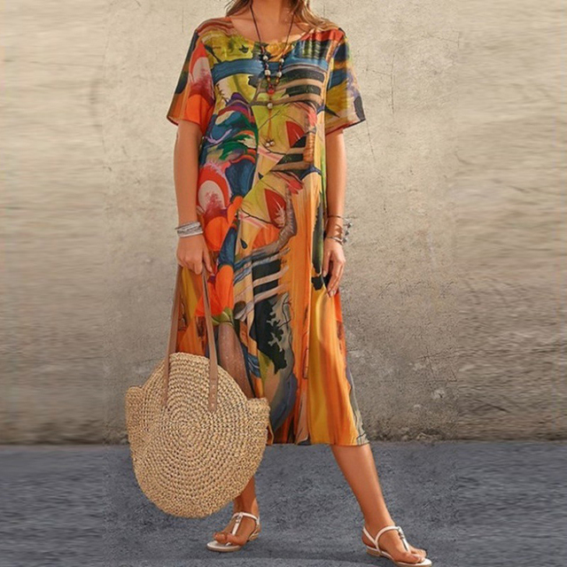Orange multicolour abstract print midi dress styled with round straw handbag