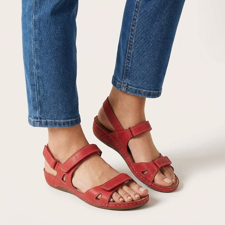 Red leather orthopedic sandals showing open toe design and adjustable straps