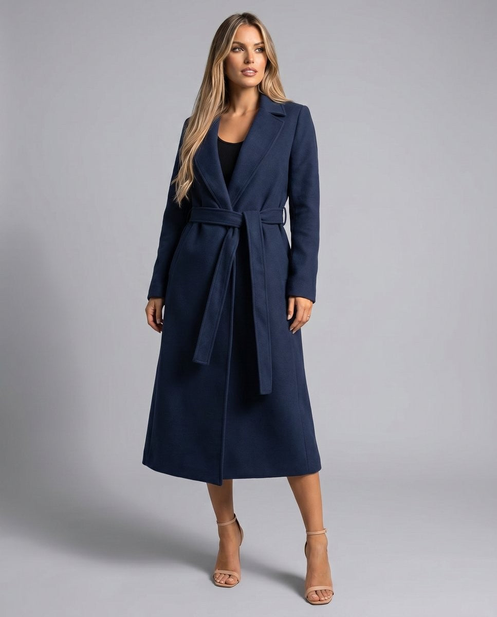 Navy longline wool coat with tie belt, worn open over a black top and heels