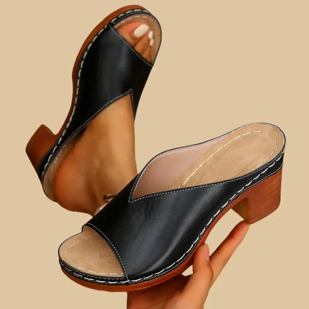 Black leather open-toe mule sandal featuring block heel and contrast stitching