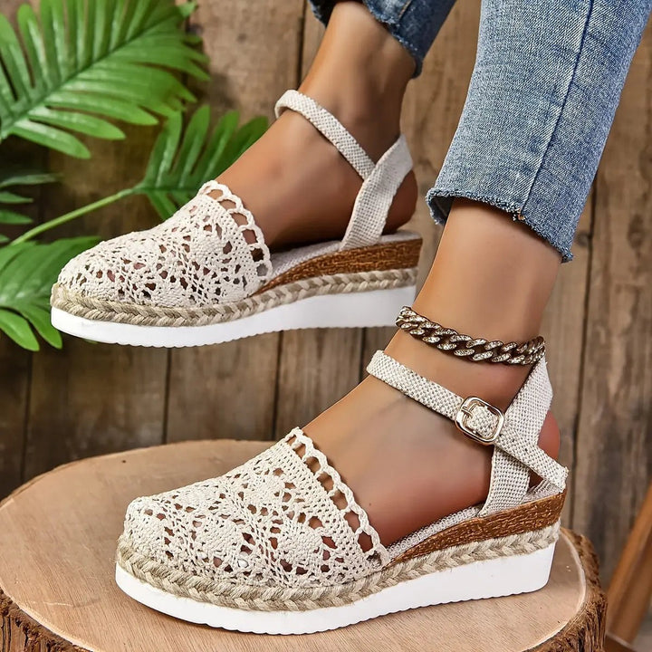 Tan crochet espadrille sandal paired with denim, styled on jute mat
