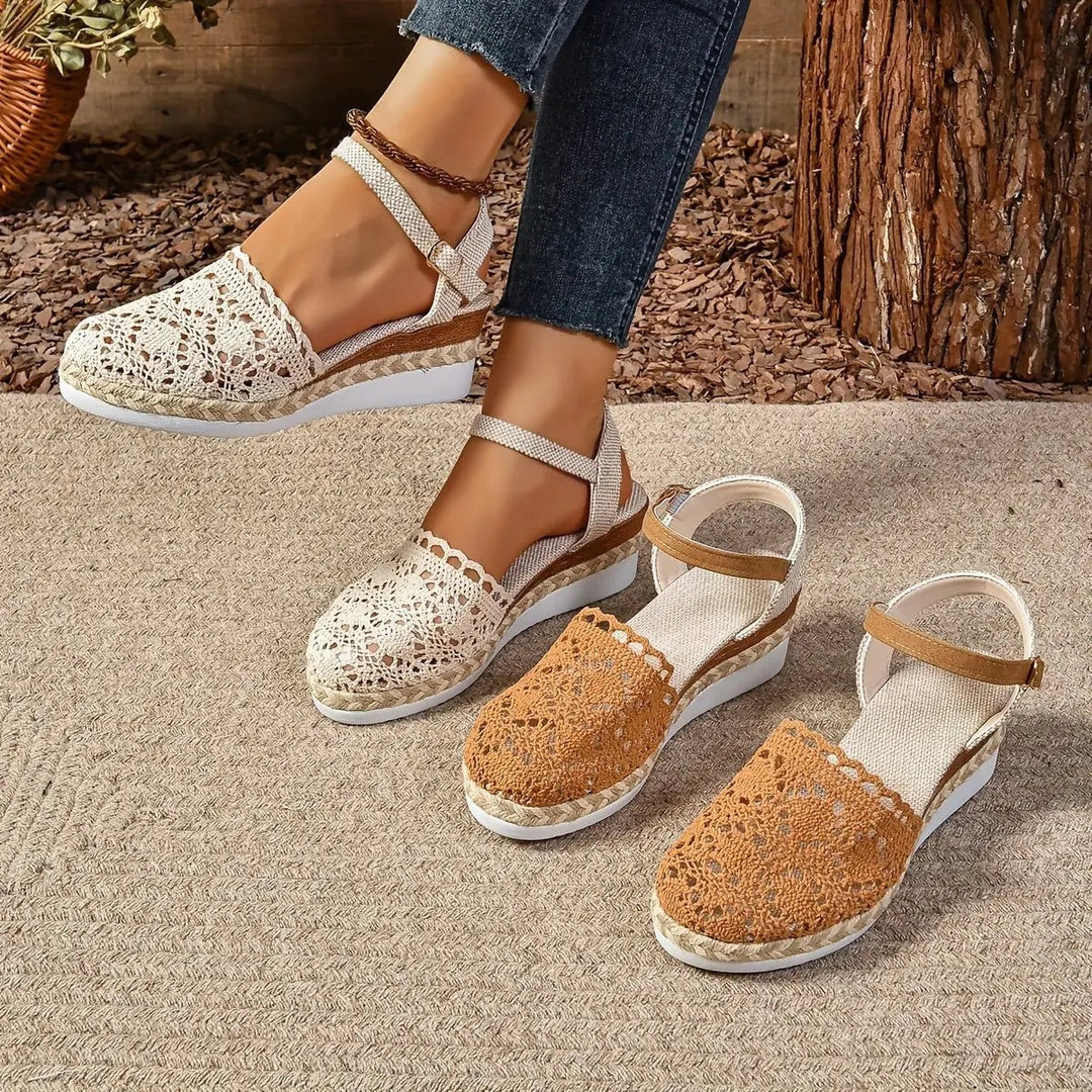 Cream and tan crochet espadrille sandals displayed together on jute rug