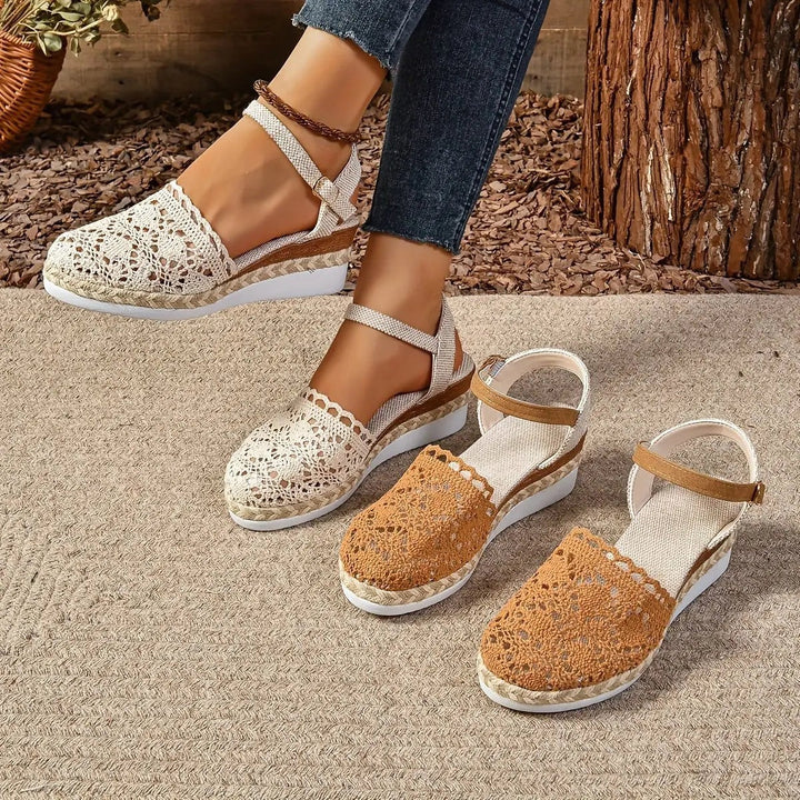 Cream and tan crochet espadrille sandals displayed together on jute rug
