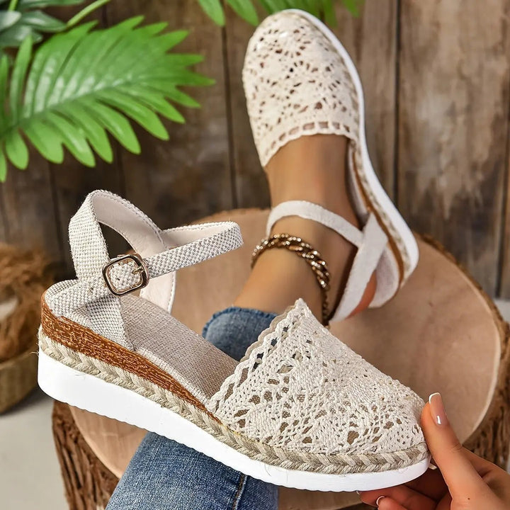 Beige crochet espadrille sandal with braided jute sole held in hand