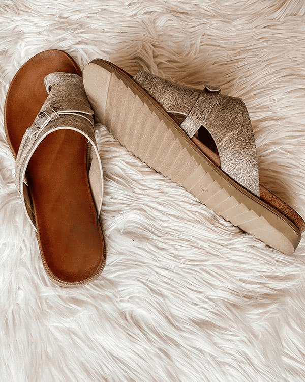 Metallic flat sandals showing ribbed sole and toe-post strap design