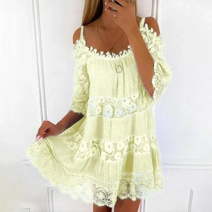 Pale yellow cold-shoulder mini dress with crochet lace trim and tiered skirt