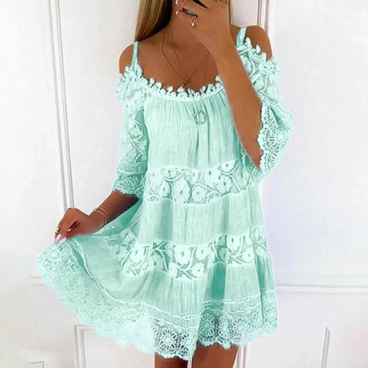 Mint green cold-shoulder summer dress featuring floral lace panels and frilled hem