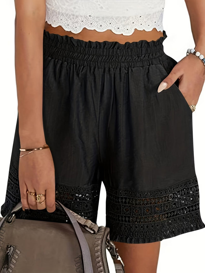 Black paperbag-waist shorts featuring crochet lace trim and slant pockets