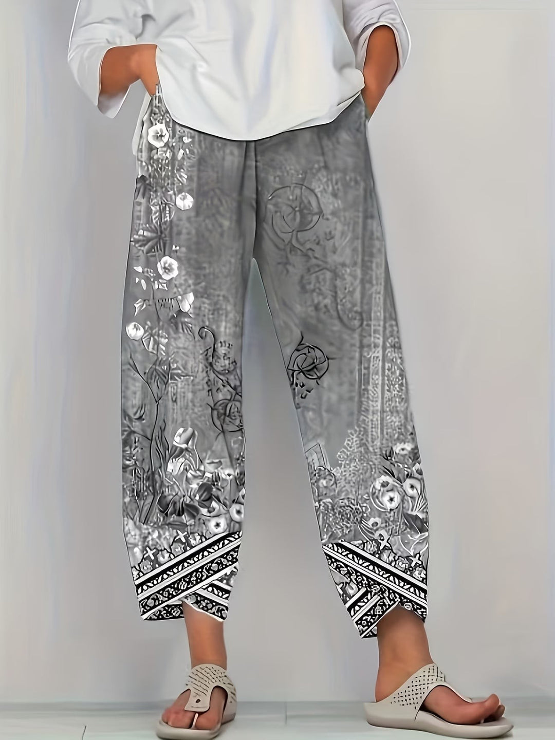 Grey vintage floral print trousers with monochrome tribal border detailing