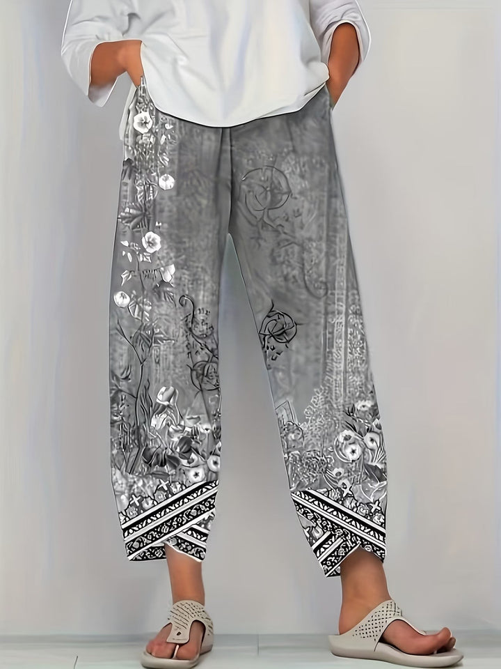 Grey vintage floral print trousers with monochrome tribal border detailing