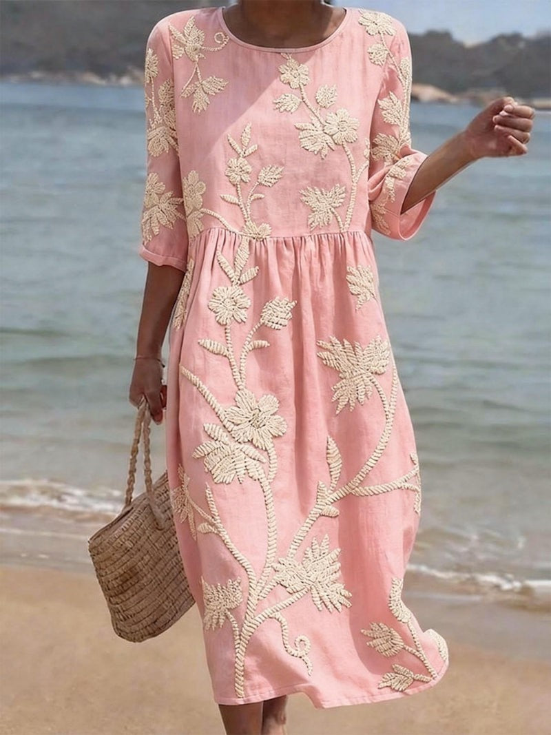 Blush pink midi dress featuring cream botanical embroidery and empire waist