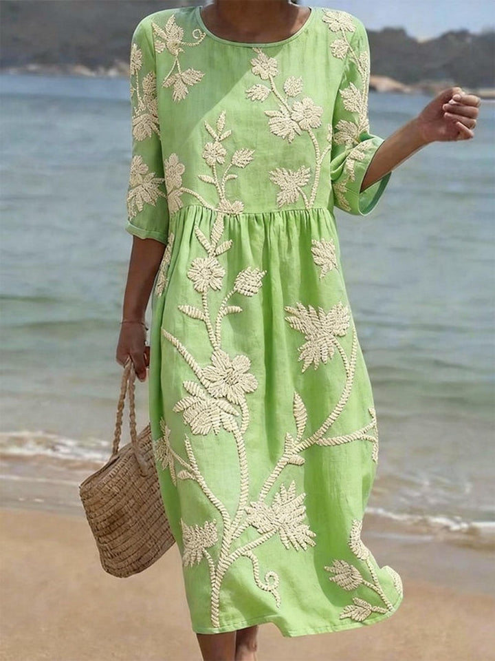 Lime green embroidered midi dress with round neck worn on beach