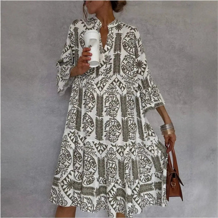 Khaki floral print tunic dress worn with brown leather handbag