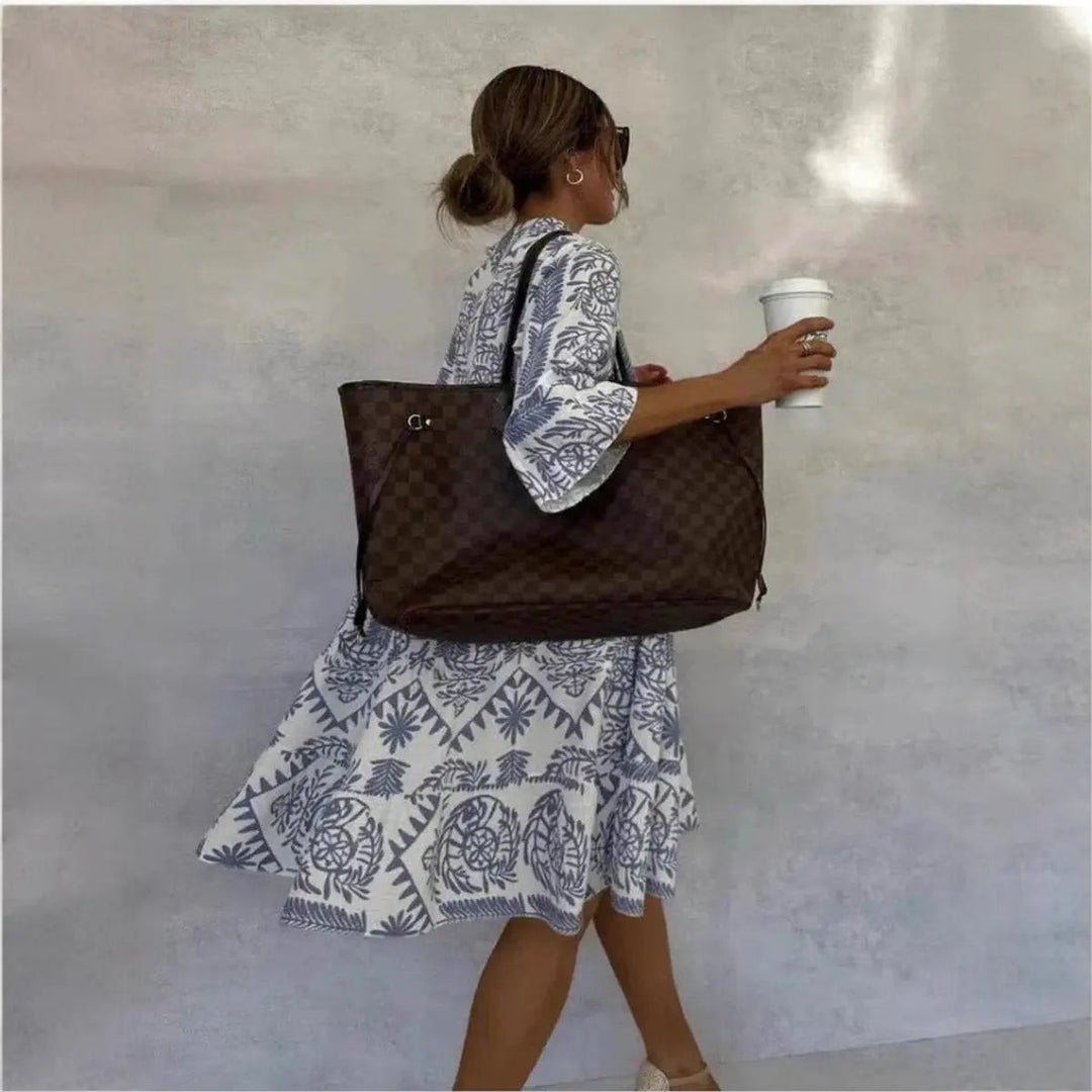 Loose fit blue floral tunic dress flowing as model walks