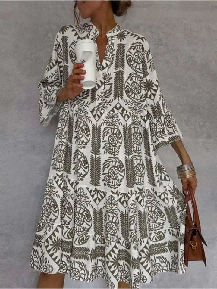Olive green floral tunic dress showing flared bell sleeves close up