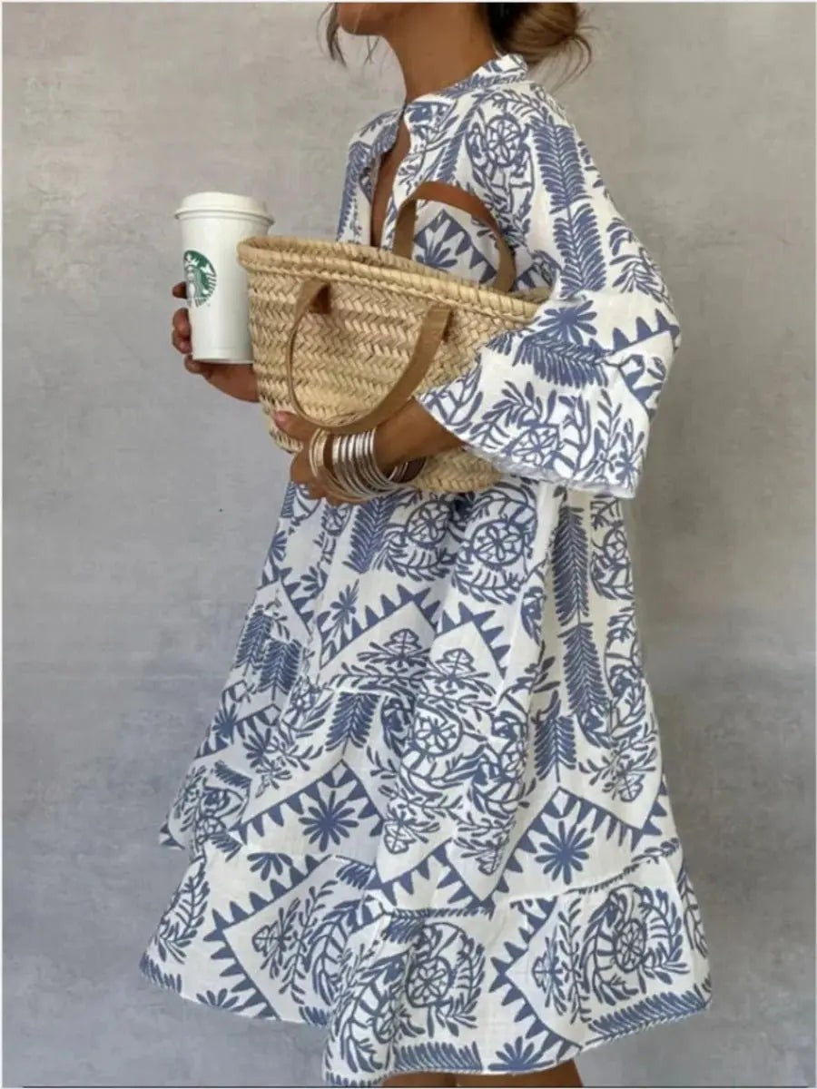 Blue and white boho print tunic dress paired with woven straw bag