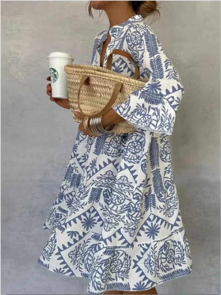 Blue and white boho print tunic dress paired with woven straw bag