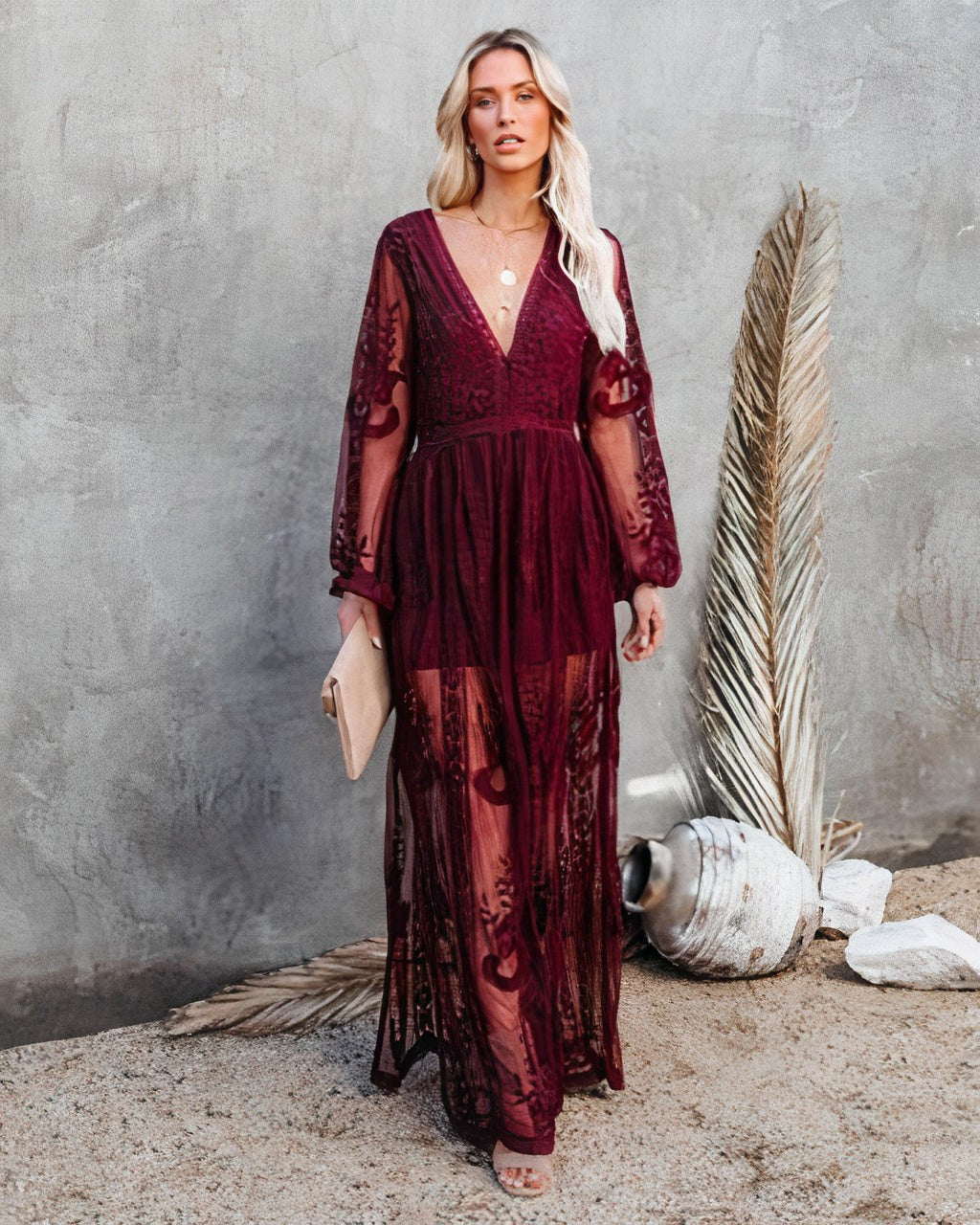 Burgundy lace maxi dress with V-neckline, bell sleeves and flowing sheer skirt