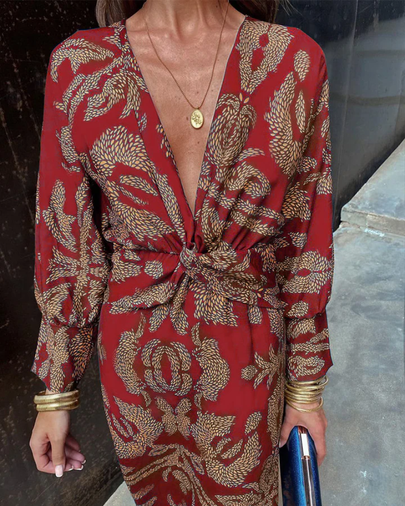 Close-up of red maxi dress showing intricate paisley print and knotted front