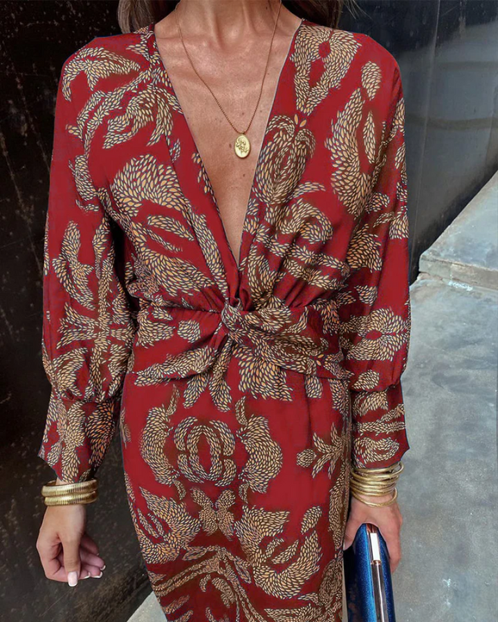 Close-up of red maxi dress showing intricate paisley print and knotted front