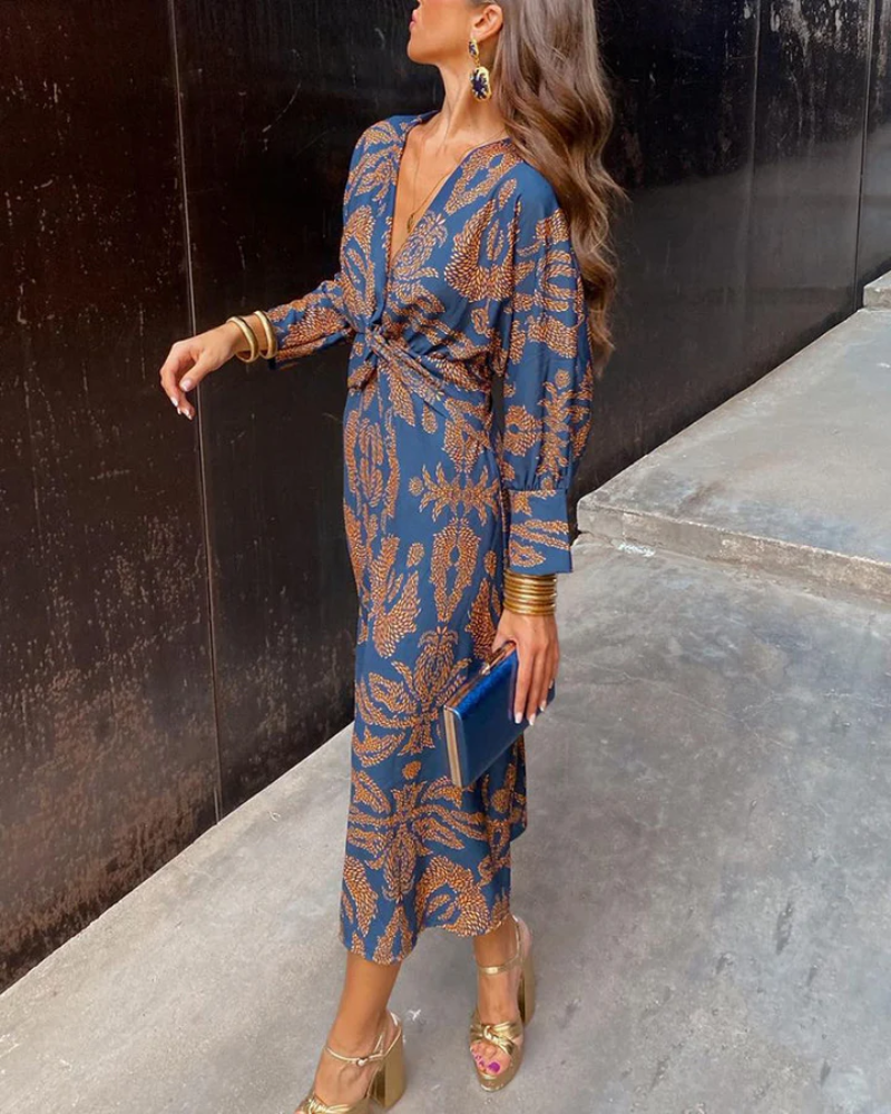 Blue paisley print maxi dress with twist-front waist and long sleeves, side view