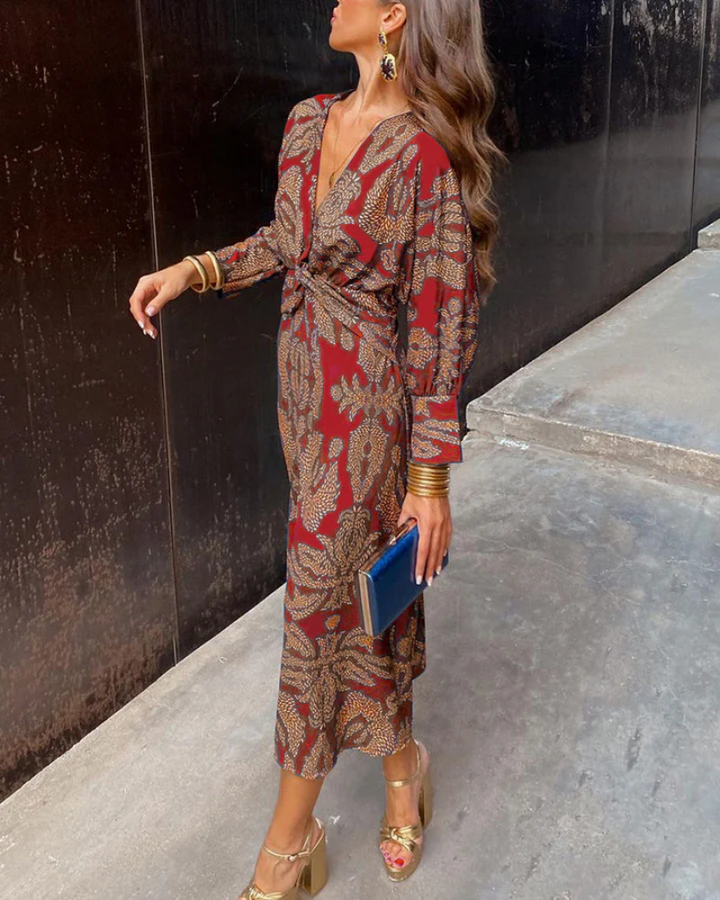 Red paisley print maxi dress with long sleeves worn with gold platform sandals