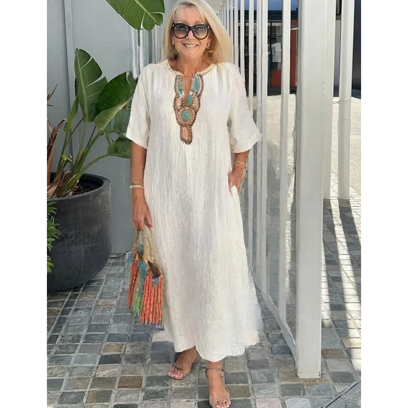 Cream boho maxi dress with embroidered neckline, worn with strappy sandals