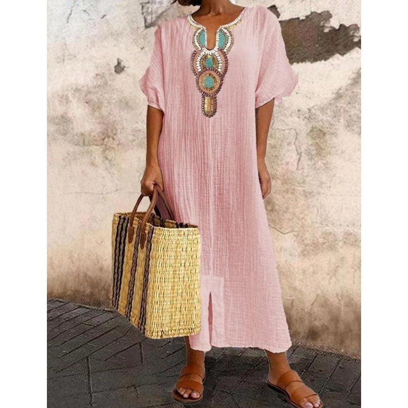 Blush pink maxi dress showcasing colourful embroidered neckline design