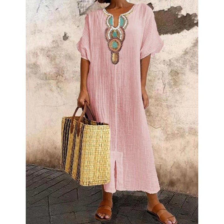 Blush pink maxi dress showcasing colourful embroidered neckline design
