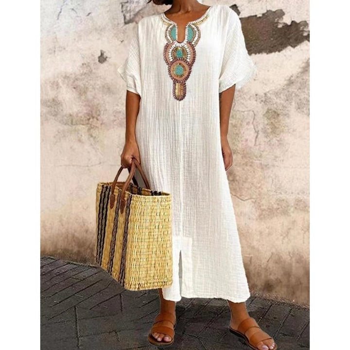 White cotton maxi dress with intricate embroidered boho neckline detail
