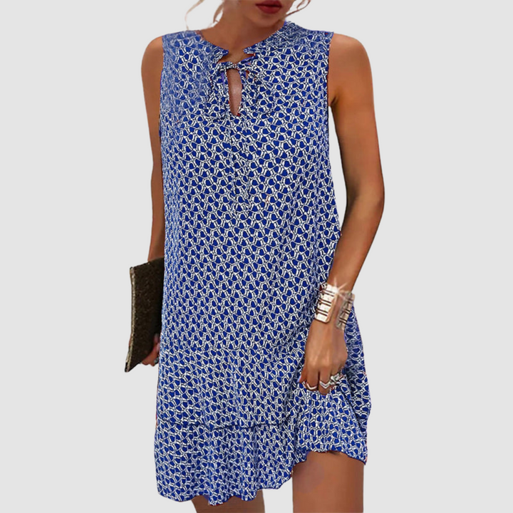 Blue geometric print sleeveless shift dress with tie-neck detail and ruffled hem