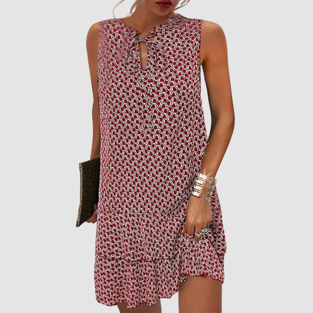 Red geometric print sleeveless shift dress with tie-neck detail and ruffled hem