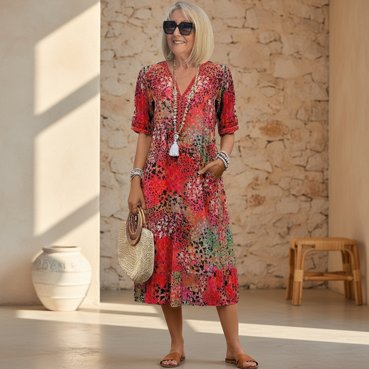 Red patchwork print midi dress with V-neck and half sleeves, styled with straw bag