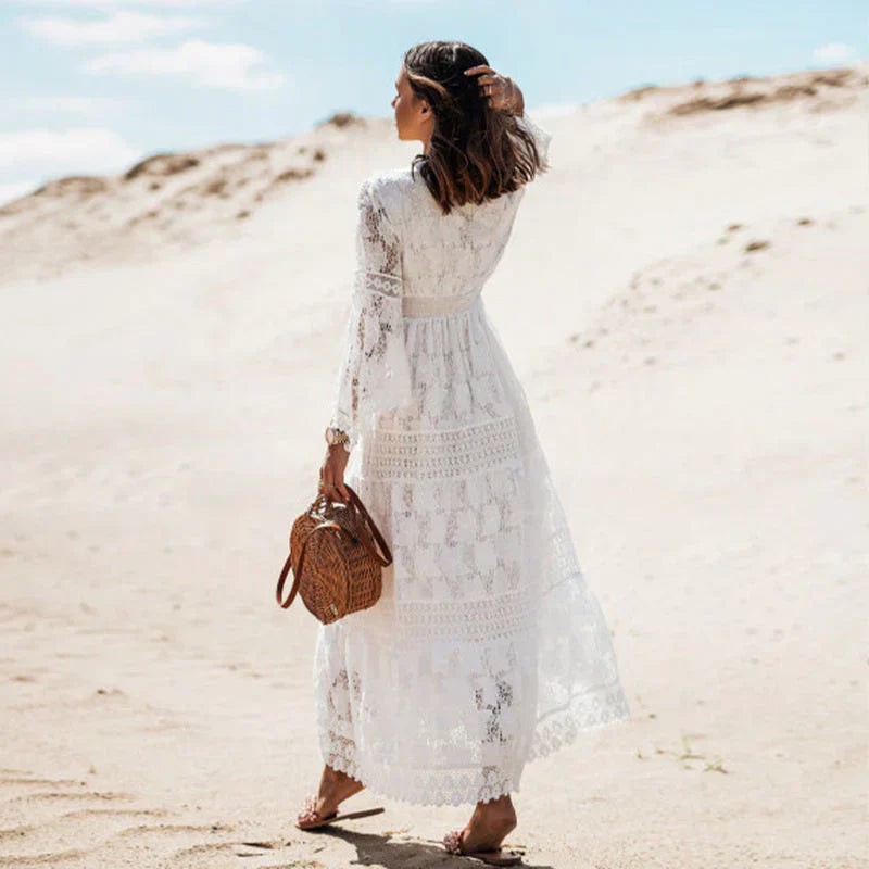 Rear view of white lace long sleeve maxi dress paired with a woven straw handbag