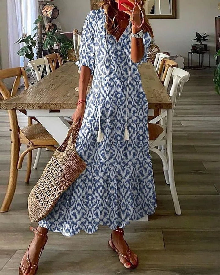 Blue and white ikat-print maxi dress with tasselled tie neckline and half sleeves