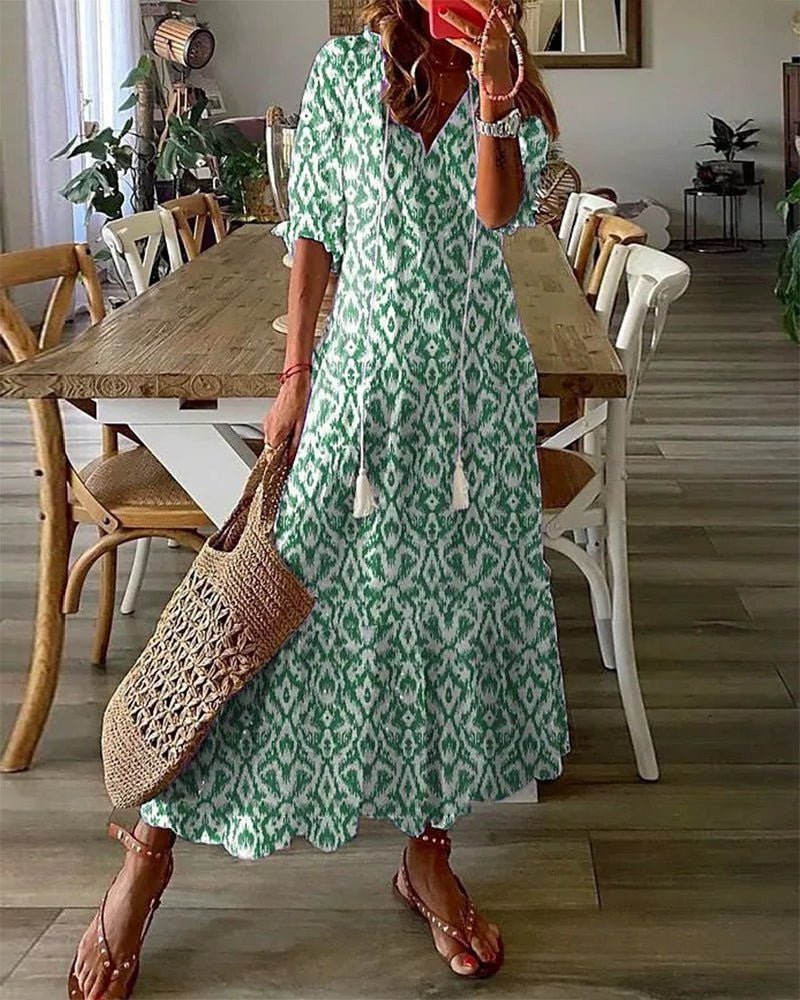 Green and white ikat-print boho maxi dress featuring a tasselled V-neck tie