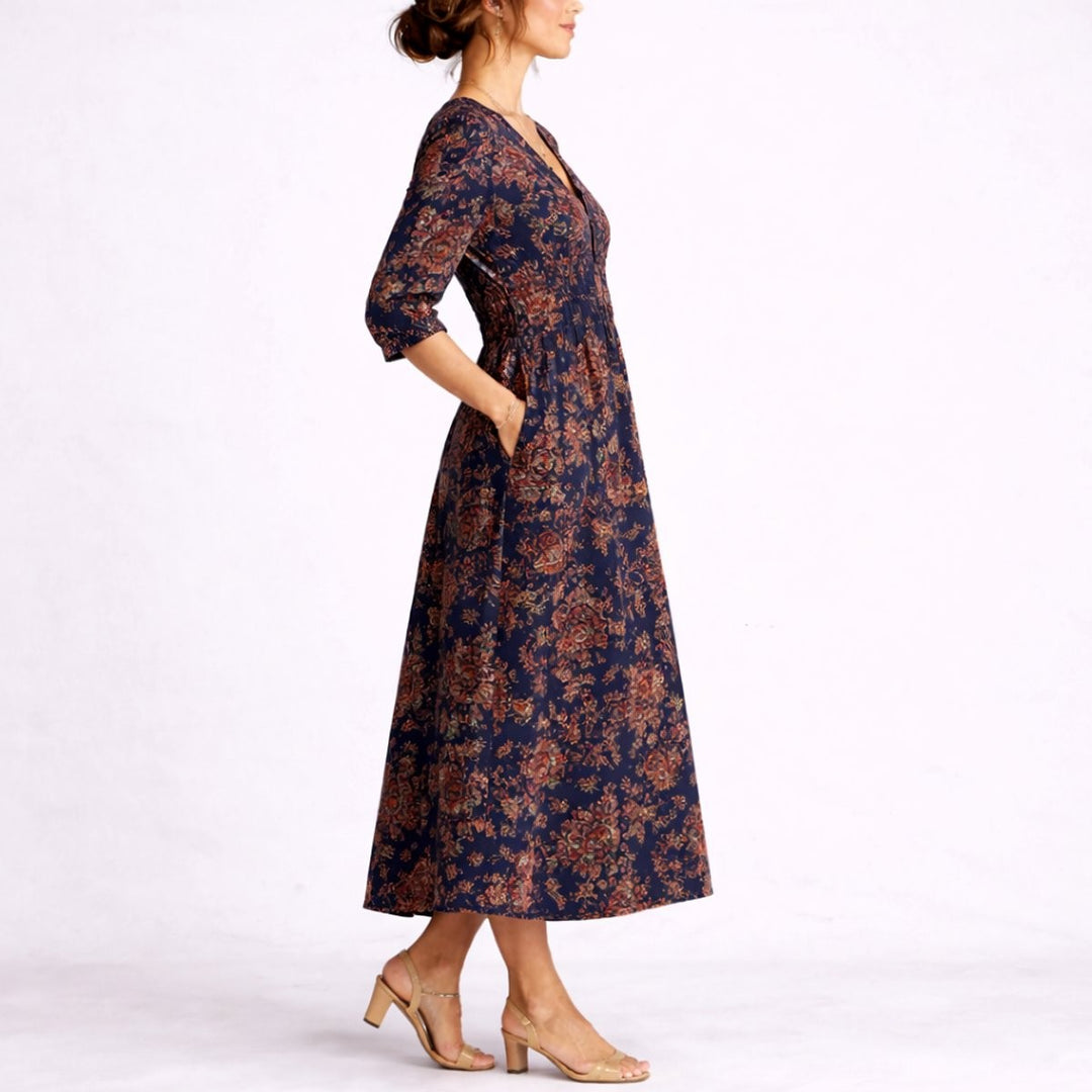 Side view of navy floral linen maxi dress with fitted waist and pockets