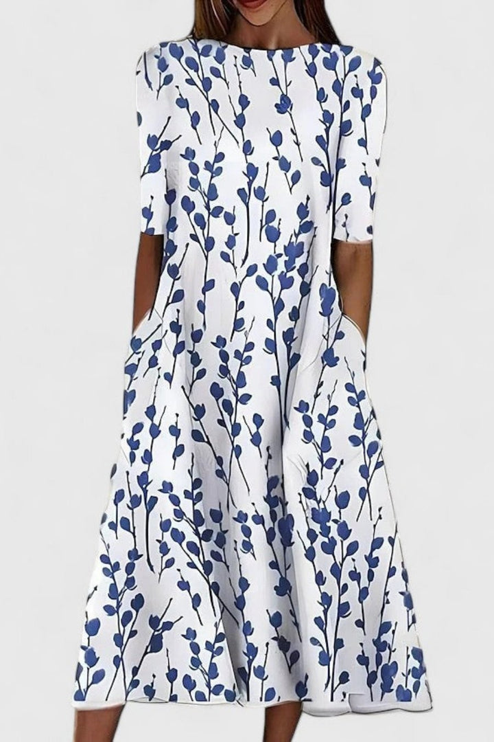 White midi dress with blue botanical print, round neck and short sleeves