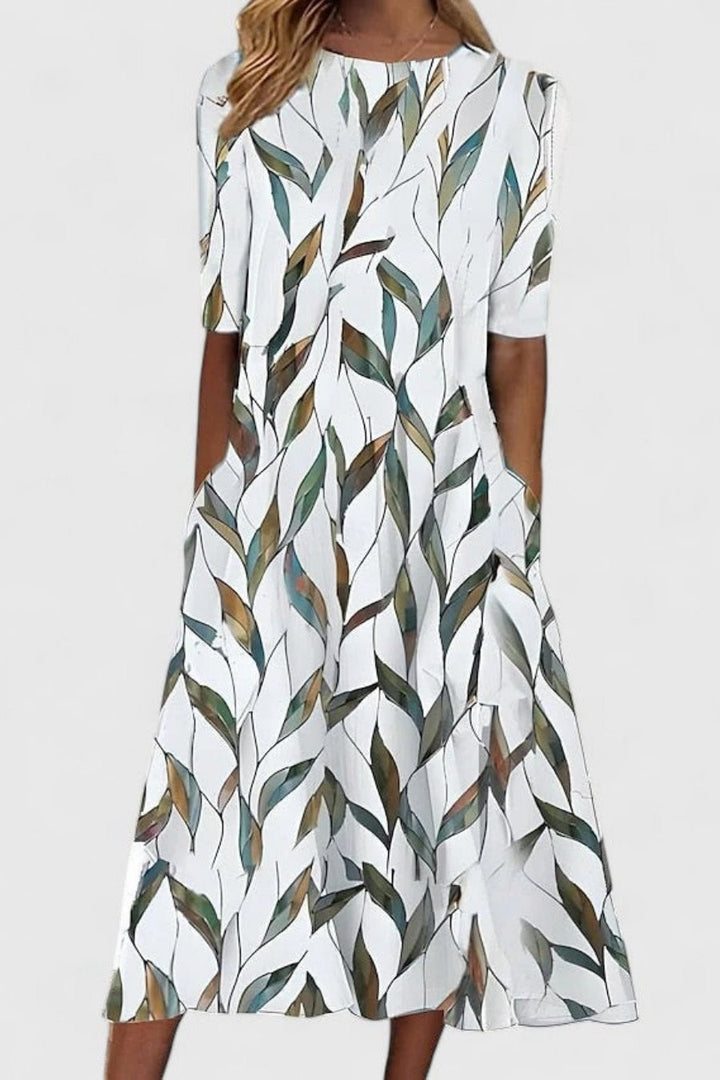 Leaf-print midi dress in white with green and gold tones, A-line shape