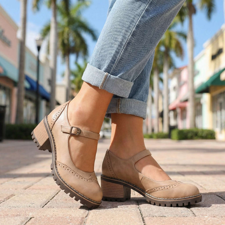 Beige leather Mary Jane pumps featuring wingtip brogue detailing and chunky heel