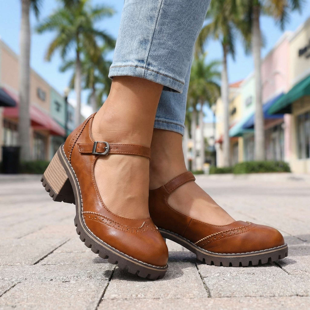 Tan leather T-strap heels with brogue perforations and stacked block heel