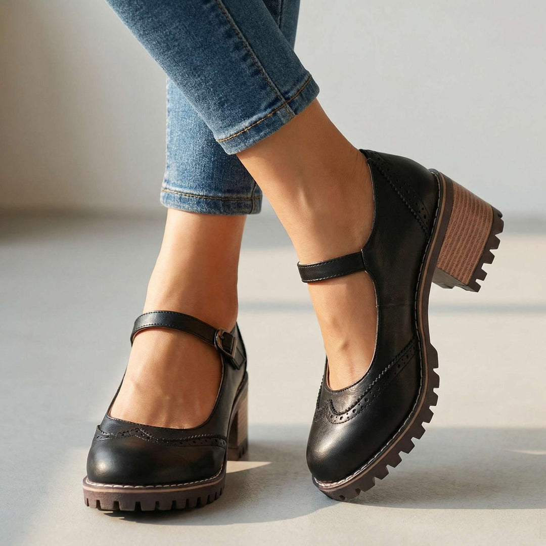 Black T-strap Mary Jane heels with brogue trim and lugged sole