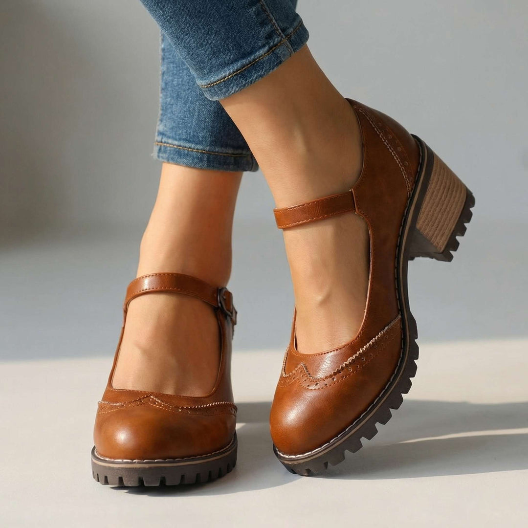 Tan leather Mary Jane shoes with wingtip brogue design and block heel